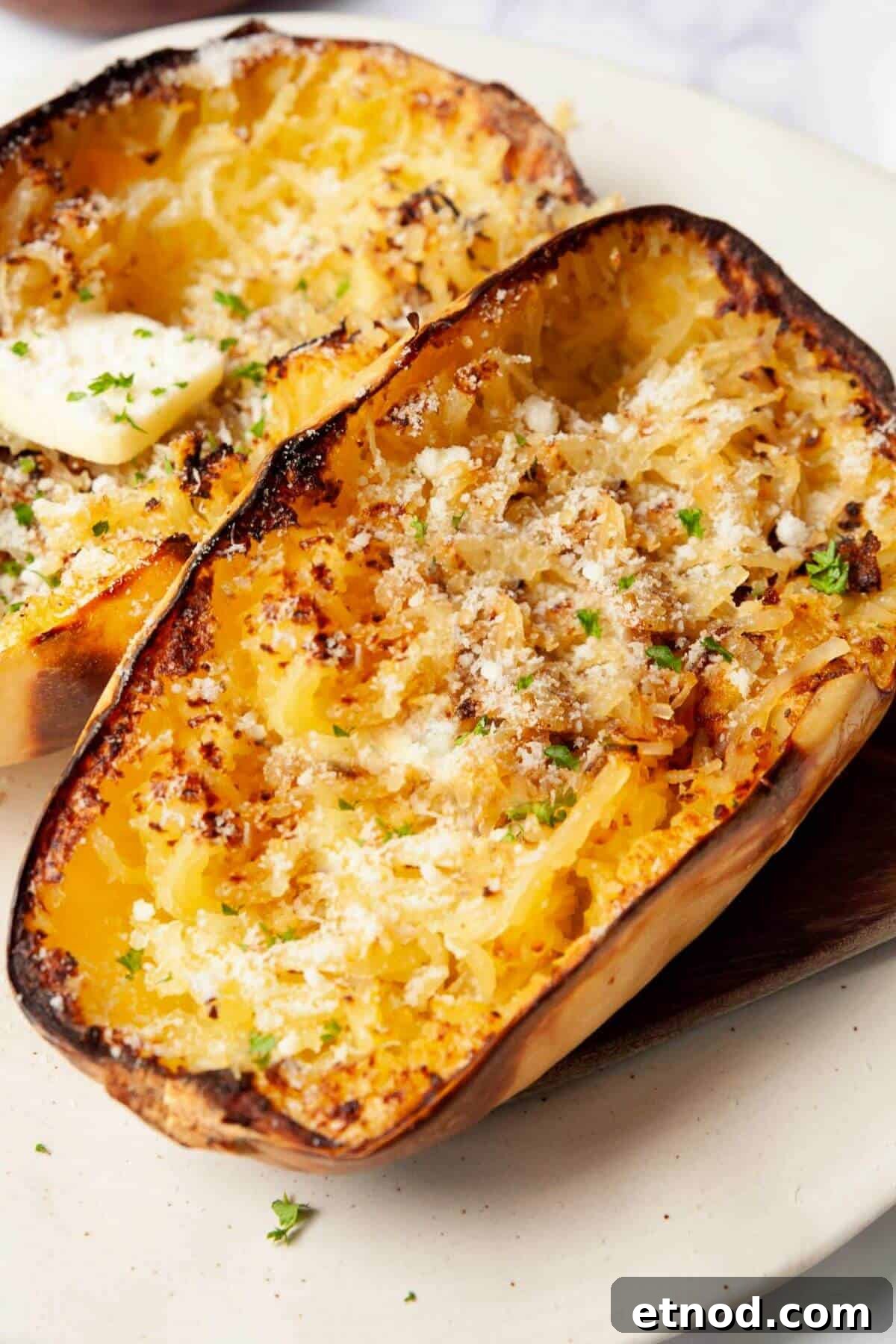 Crispy Air-Fried Spaghetti Squash Recipe 2 Fluffy air fryer spaghetti squash noodles topped with melted butter and grated parmesan.