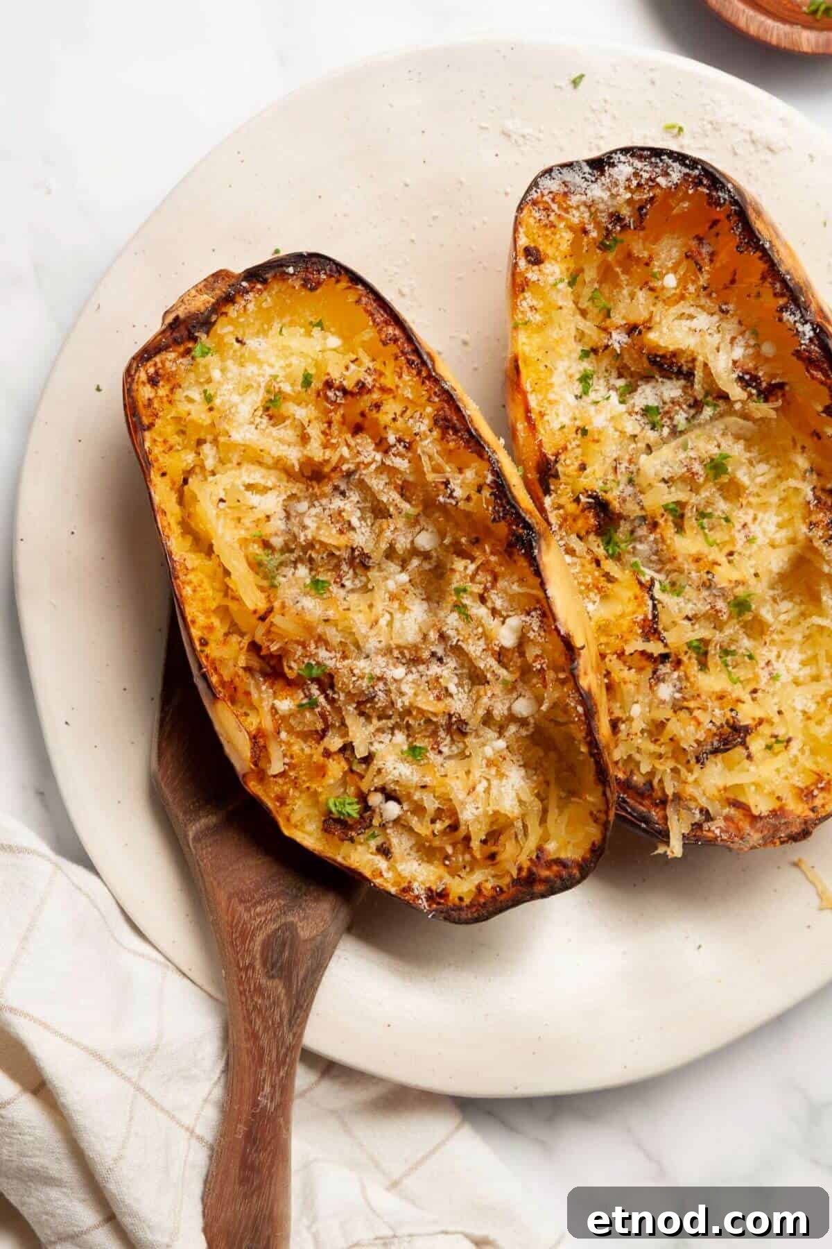 Crispy Air-Fried Spaghetti Squash Recipe 9 Golden, tender air fryer spaghetti squash halves with parmesan cheese and parsley.