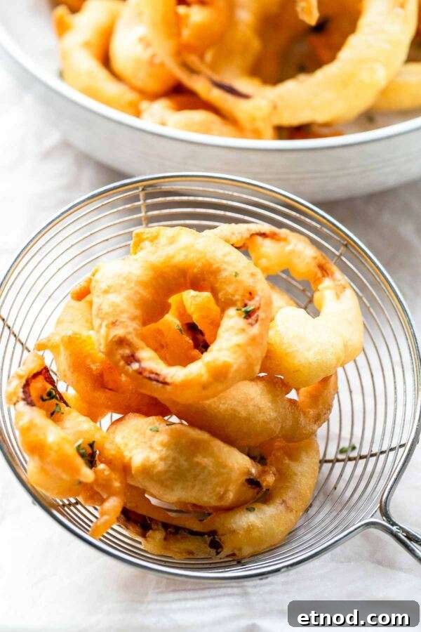 Super easy snack Crispy Onion Rings are made with a simple batter and are deep fried. Serve as a side dish or a snack. Dip in a great dip sauce and serve on the side with a hamburger, ribs or steak.