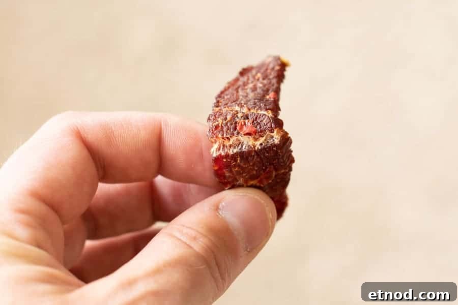 Cherry Bomb Beef Jerky: Spicy-Sweet Gourmet Snack 13 Finished jerky being bent