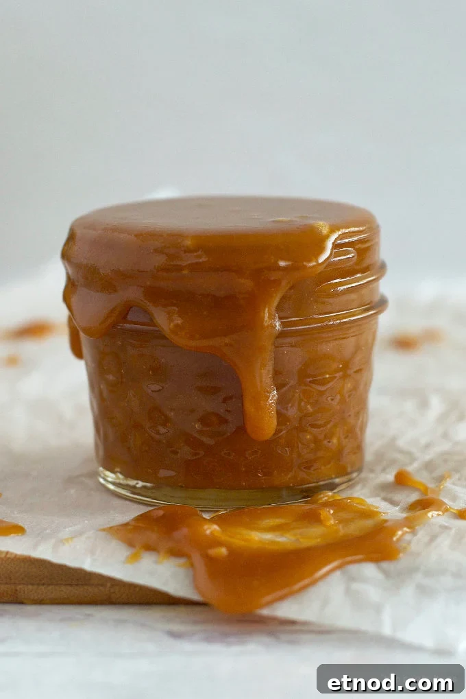 Creamy Cookie Butter Caramel Sauce Recipe 16 cookie butter caramel sauce overflowing over a jar