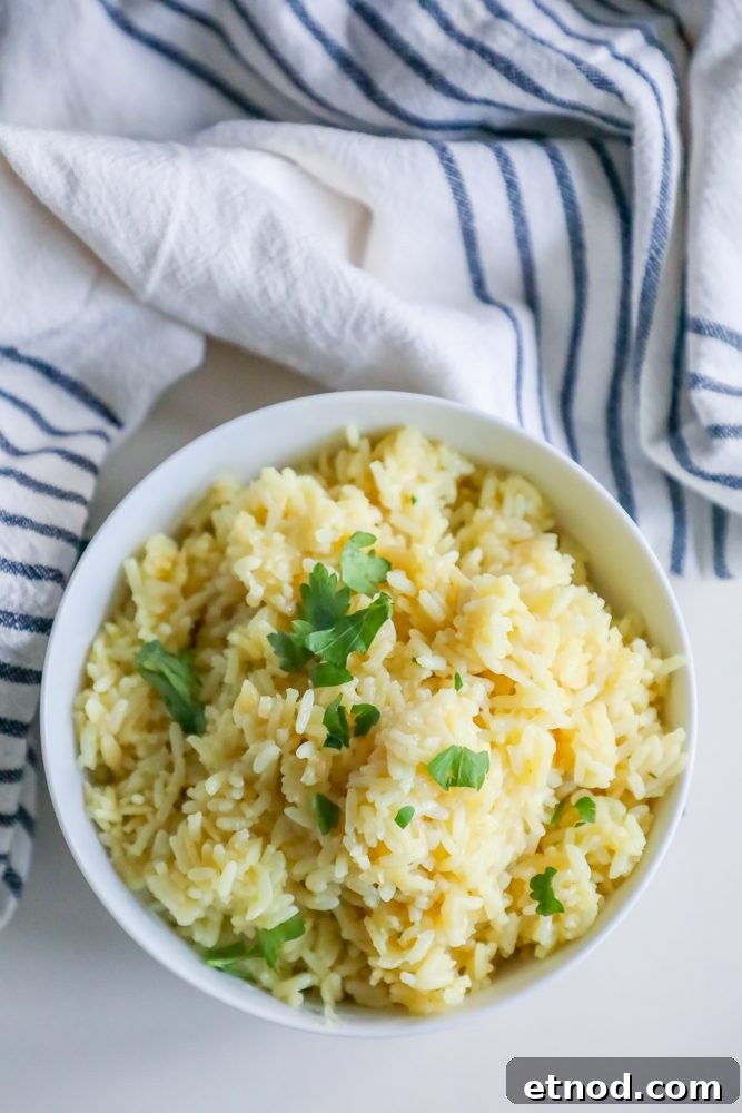 Perfect Rice Pilaf Recipe You Can Make Tonight 3 rice pilaf with parsley on it in a white bowl with towel around it