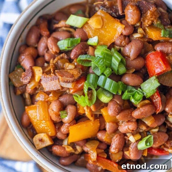 Perfect Rice Pilaf Recipe You Can Make Tonight 8 A bowl of delicious Mexican beans mixed with diced bell peppers, onions, and topped with chopped green onions.