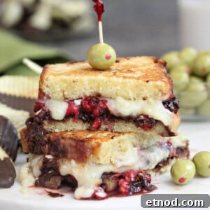 Close up of a Dessert Grilled Cheese Sandwich with melty cheese and olive on top.