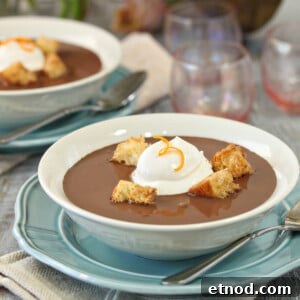 Close up of a bowl of Chocolate Soup with croissant croutons and creme fraiche.