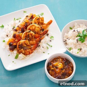 Garam Masala Shrimp with Mango Chutney Recipe for Quick Dinner 2 Overhead view of Garam Masala Shrimp on a square white platter with a bowl of white rice and salsa on the side