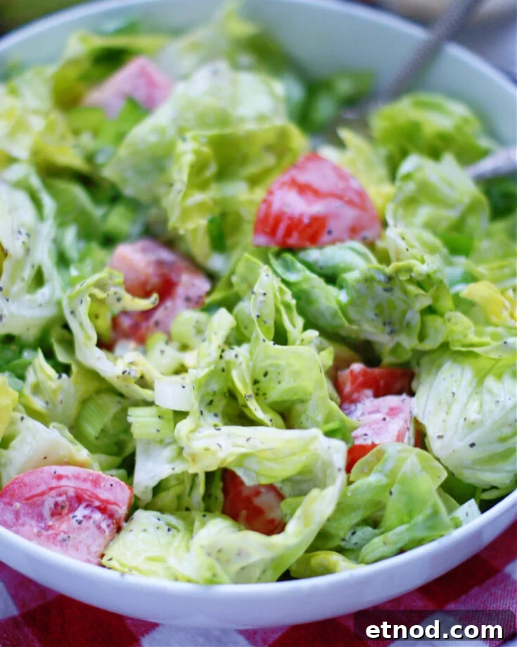 up close of green salad with creamy mayo dressing to show ingredients and texture
