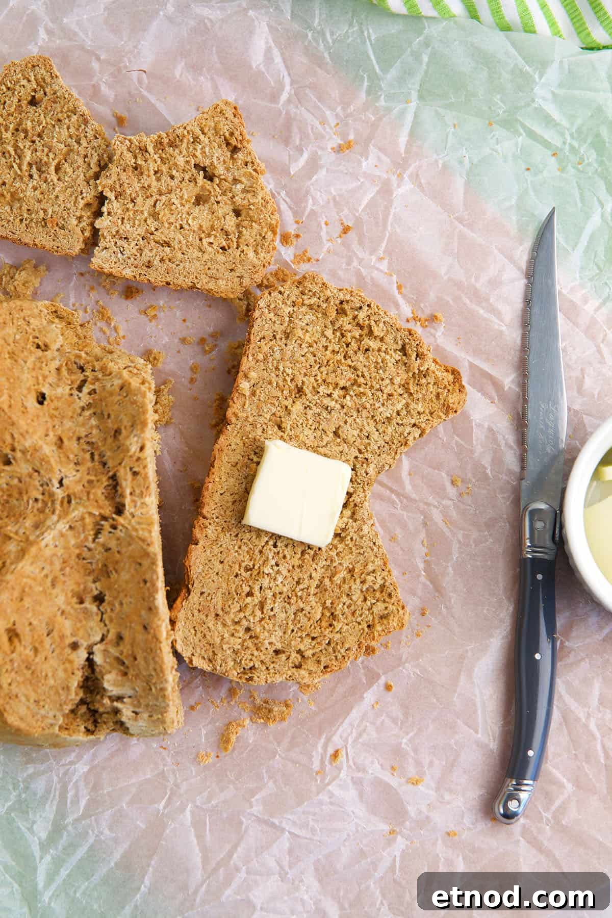 Traditional Irish Brown Bread Recipe — Rustic Soda Bread Guide 5 A slice of butter is placed on a piece of bread.