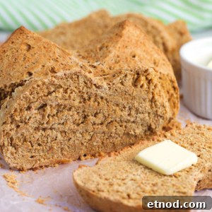 Traditional Irish Brown Bread Recipe — Rustic Soda Bread Guide 6 A slice of Irish brown bread has been cut from the loaf.