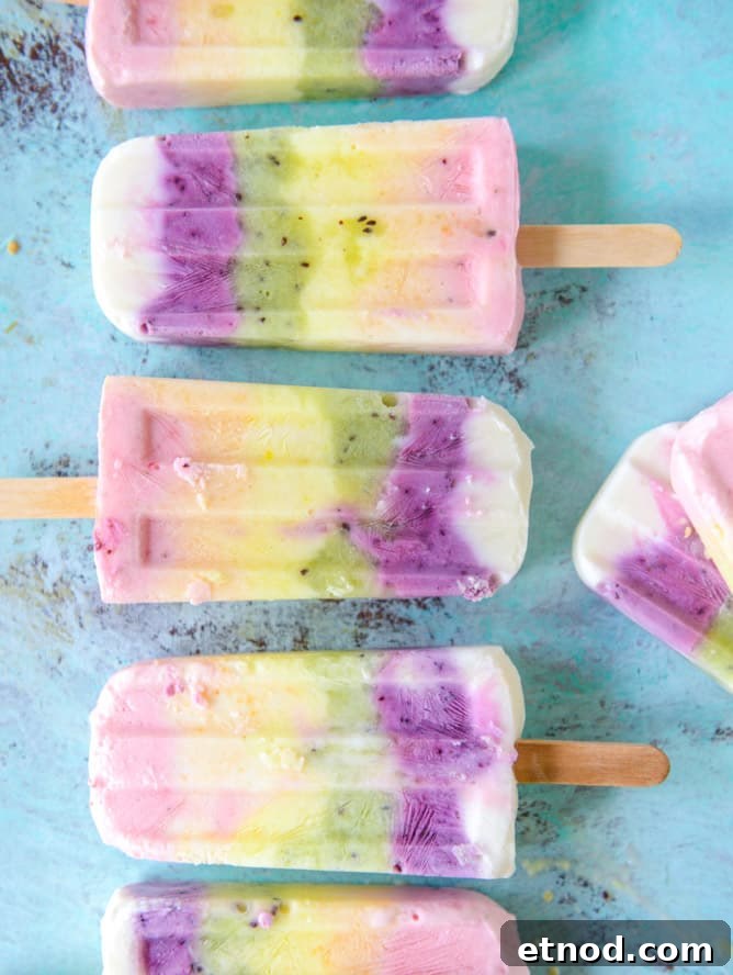 Rainbow Fruity Frozen Yogurt Popsicles: Refreshing Summer Treat 9 rainbow froyo pops I howsweeteats.com