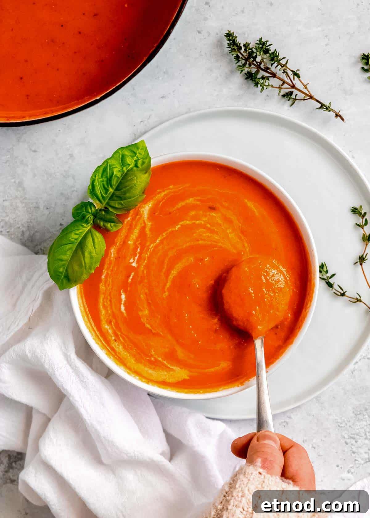 Creamy Roasted Red Pepper Soup with Garlic and Basil 17 a spoon full of roasted red pepper and tomato soup