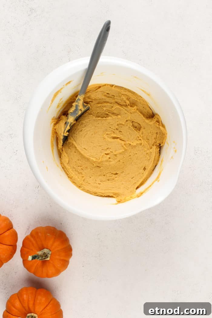 Chewy Pumpkin Snickerdoodles Recipe for Fall Baking 6 Pumpkin snickerdoodle dough in a white mixing bowl.