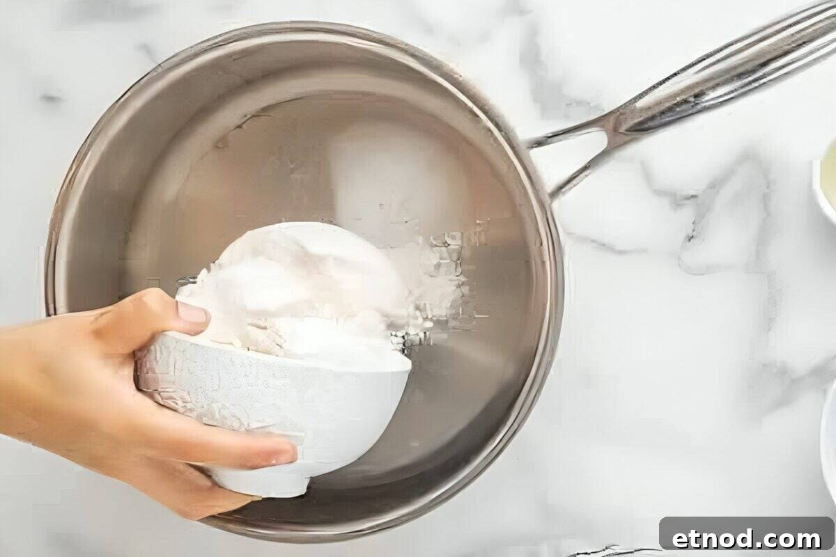 Make Homemade Kool-Aid Play Dough: Bright, Scented Recipe 10 Pouring flour into a saucepan.