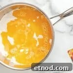 Make Homemade Kool-Aid Play Dough: Bright, Scented Recipe 6 Water and oil added to a pan of Kool-aid powder.