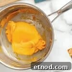 Make Homemade Kool-Aid Play Dough: Bright, Scented Recipe 7 Orange dough coming together in a pan.