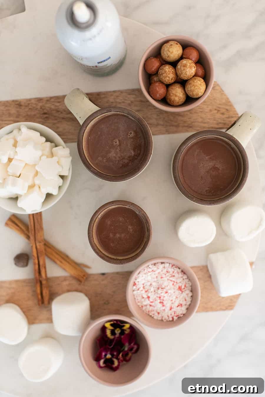 Creamy Homemade Hot Chocolate Recipe for Rich, Cozy Cocoa 6 Hot chocolate on a board with mugs filled with hot chocolate.