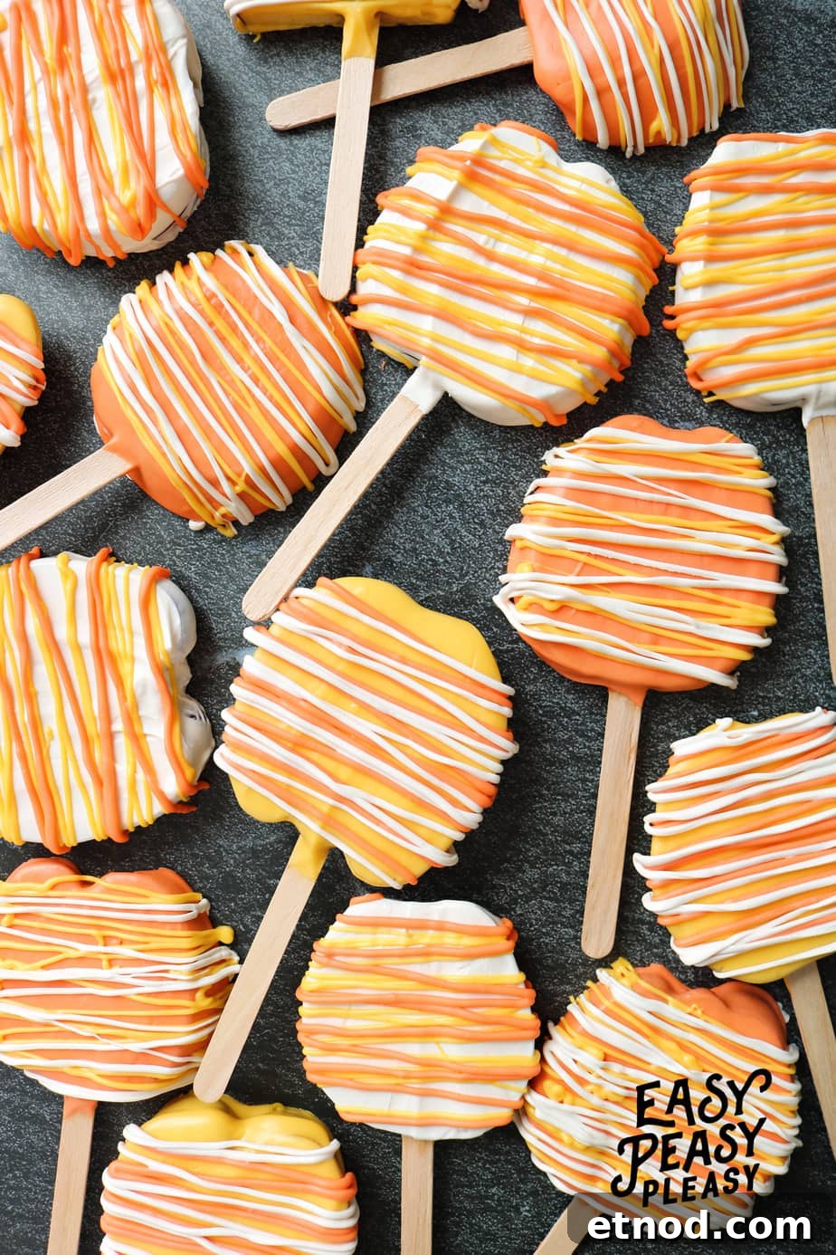Super easy 2 Ingredient Candy Apple Slices on a stick that has the look of candy corn perfect for Halloween.