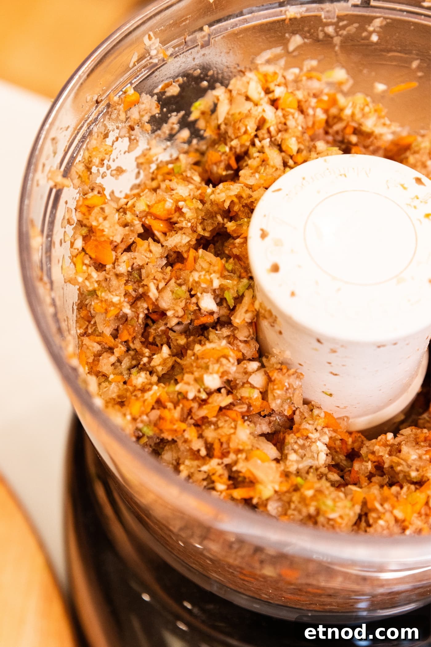 Classic Comfort Meatloaf Recipe for Perfect Weeknight Dinners 8 Processing container of food processor filled with chopped vegetables after being ground by blade.