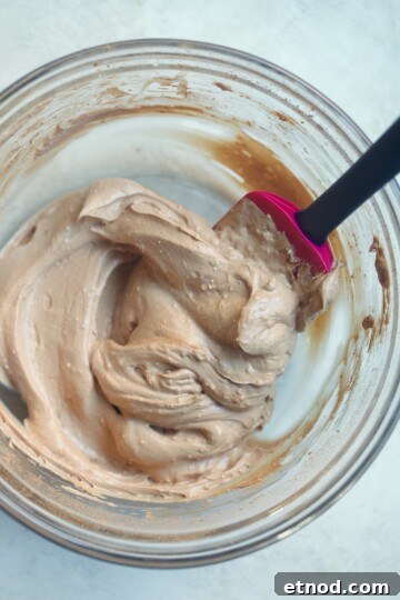 Chocolate Cream Cheese Frosting Recipe with Reduced Sugar 5 spatula mixing frosting.