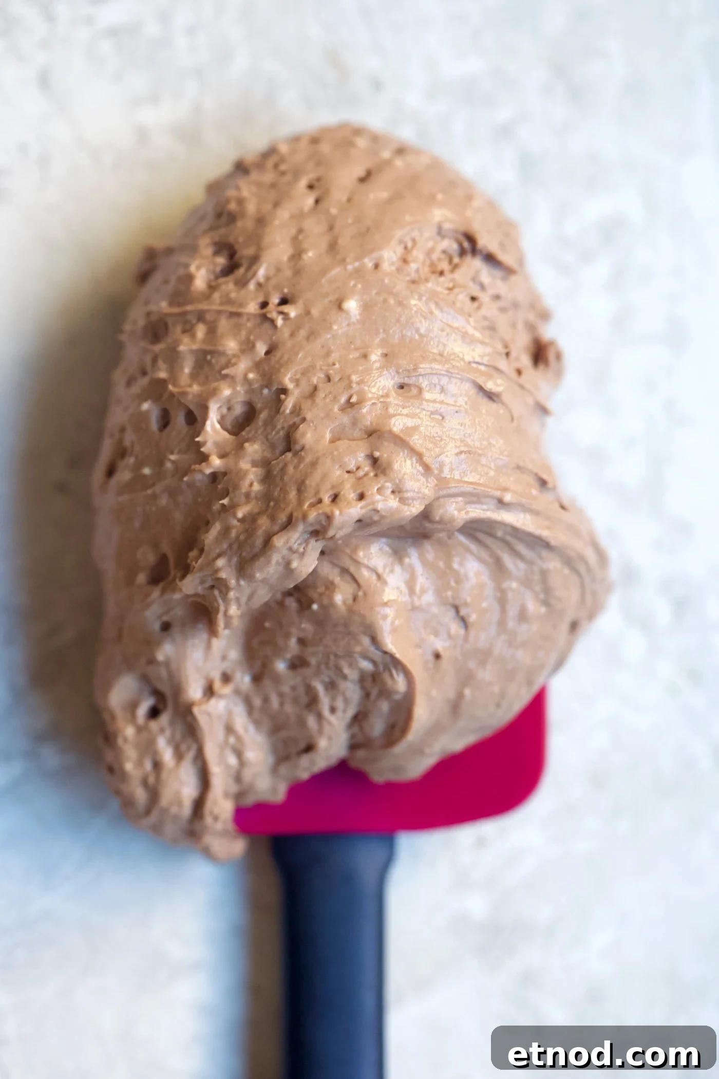 Chocolate Cream Cheese Frosting Recipe with Reduced Sugar 8 chocolate frosting on spatula.