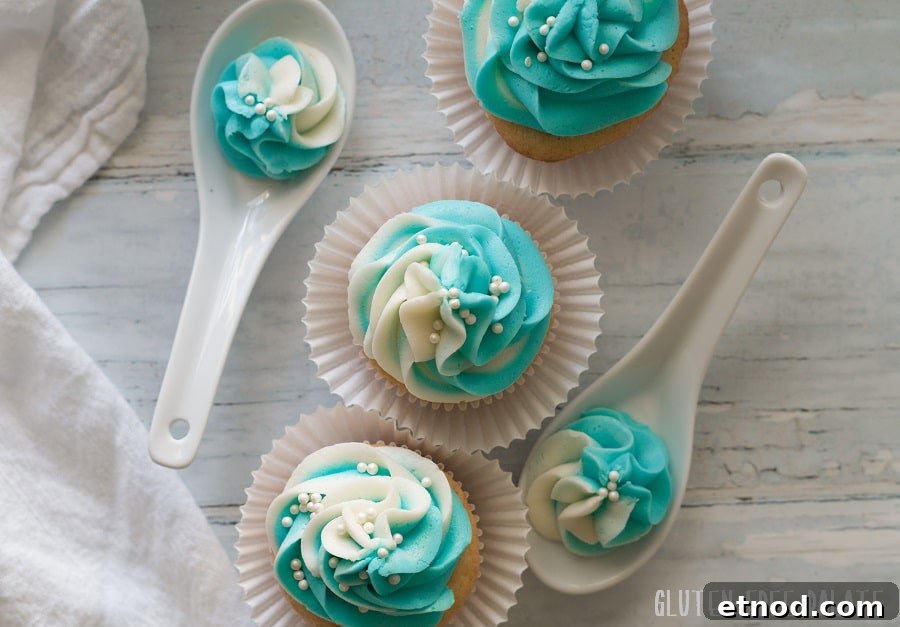 Gluten-Free Vanilla Cupcakes Recipe for Light, Fluffy Results 6 Top down view of vanilla cupcakes with blue and white swirled frosting