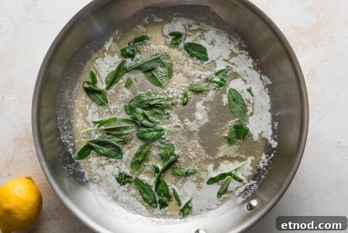 Brown Butter Ravioli with Roasted Butternut Squash Filling 6 Melted butter in a skillet with sage leaves simmering inside.