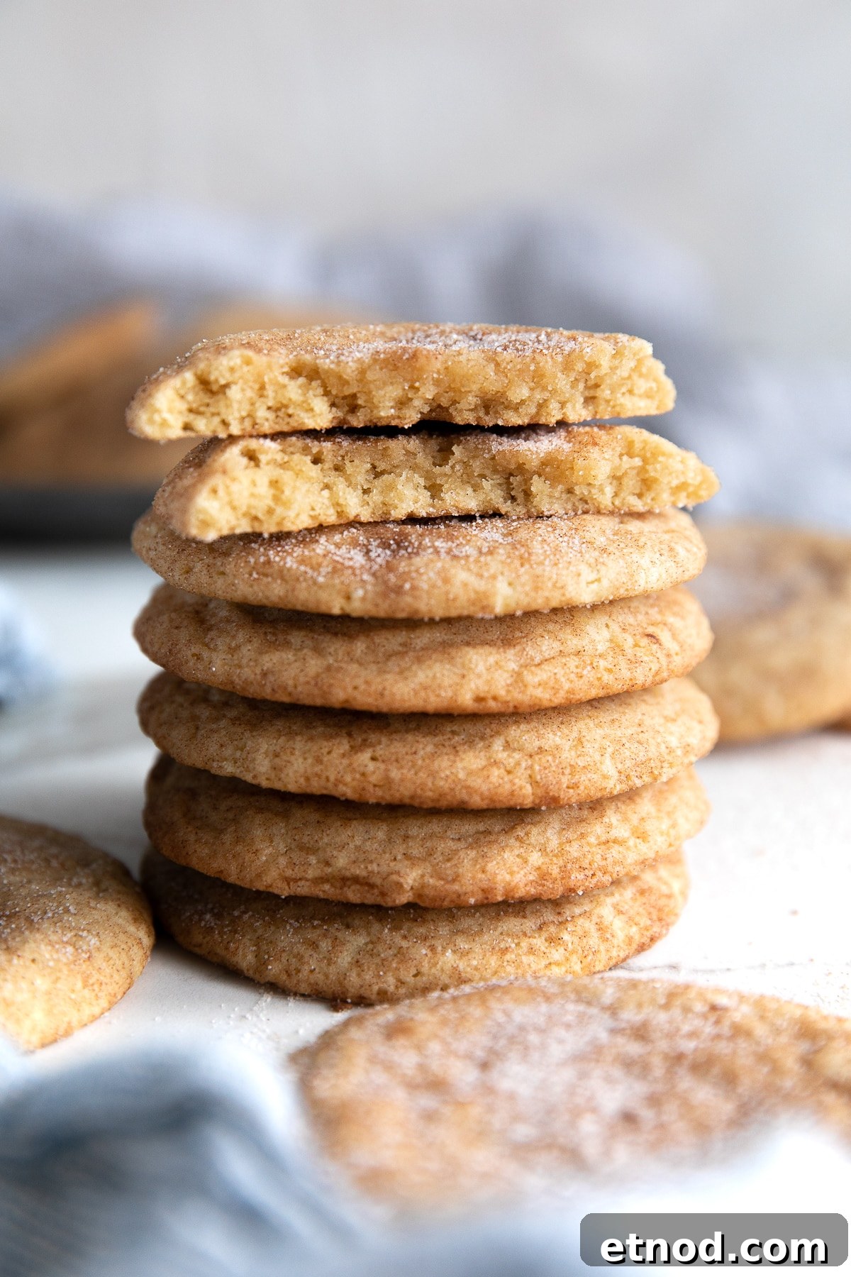 Classic Snickerdoodle Cookie Recipe: Soft Cinnamon Sugar Cookies 7 Stack of five snickerdoodle cookies topped with one snickerdoodle broken in half.