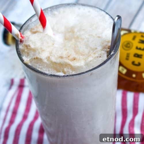 Cream Soda Float Recipe: Refreshing Homemade Ice Cream Soda 8 a cream soda float in a glass jar with two red striped paper straws
