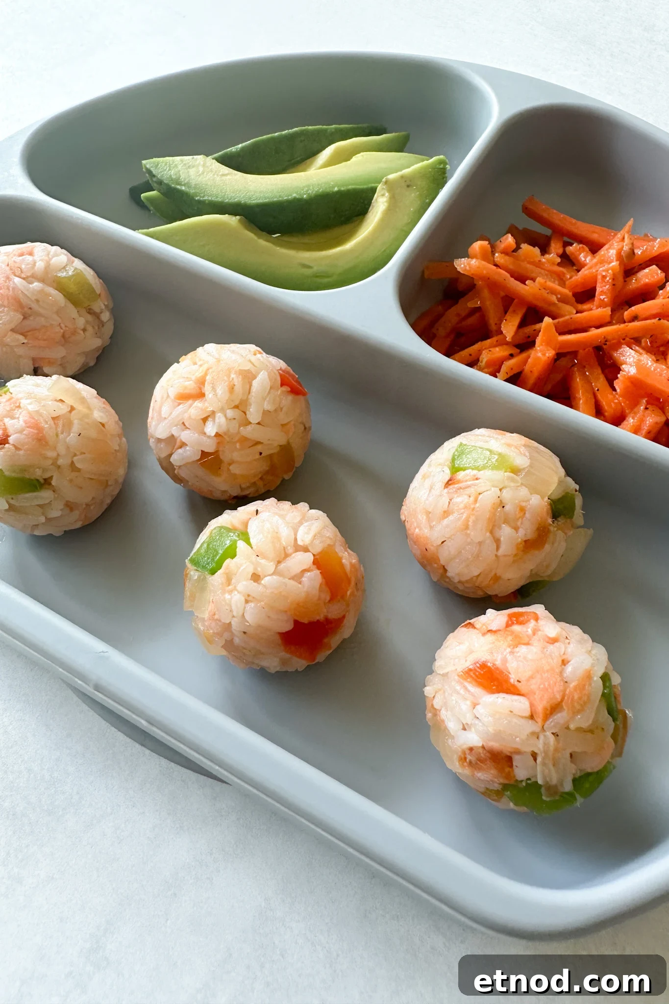 Flaky Salmon Rice Balls: Simple Recipe for Perfect Onigiri 2 Salmon rice balls served with avocado and carrots.