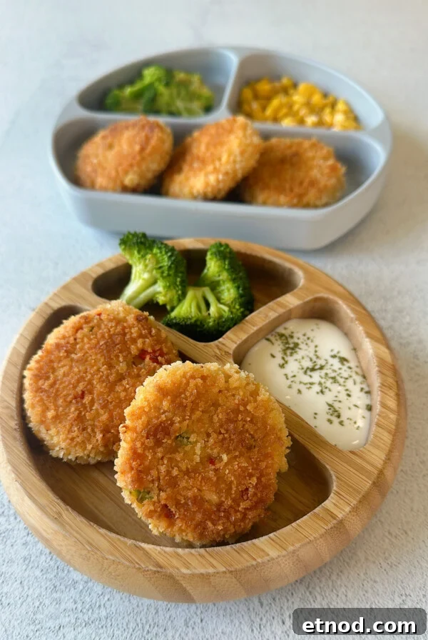 Flaky Salmon Rice Balls: Simple Recipe for Perfect Onigiri 11 Salmon cakes served with broccoli, dip, and corn.