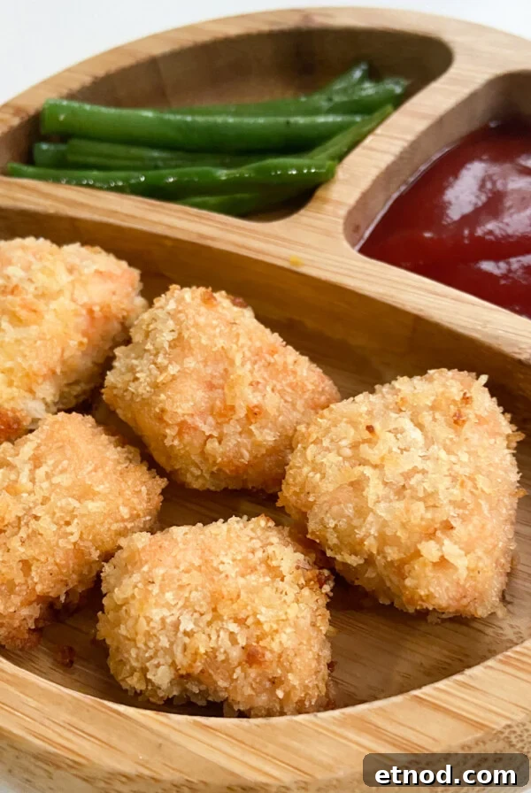 Flaky Salmon Rice Balls: Simple Recipe for Perfect Onigiri 12 Salmon nuggets served with a side of green beans and ketchup