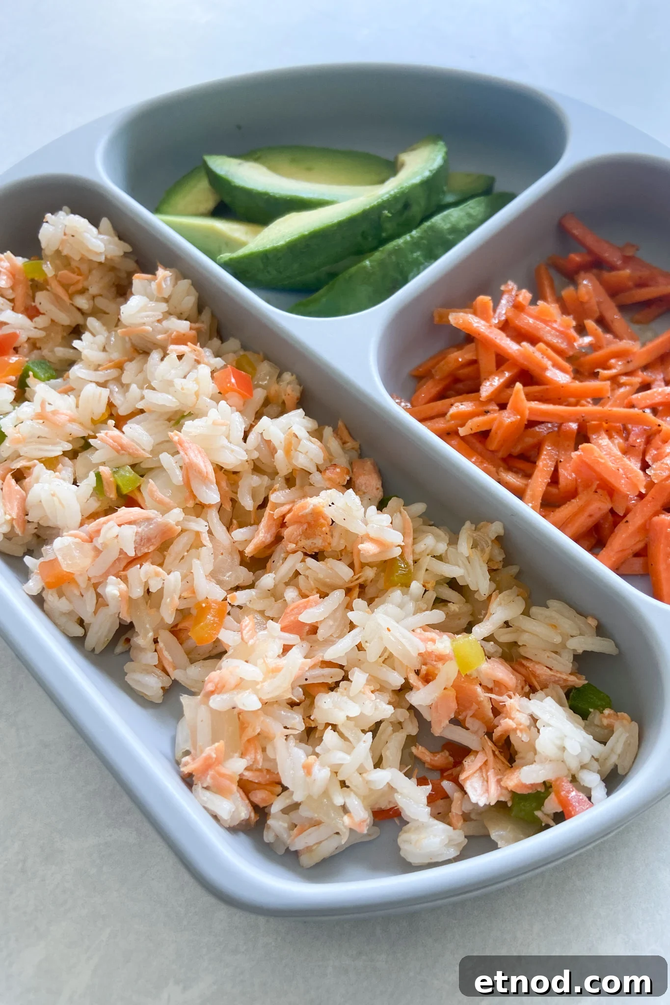 Flaky Salmon Rice Balls: Simple Recipe for Perfect Onigiri 9 Salmon rice served with avocado and carrots.