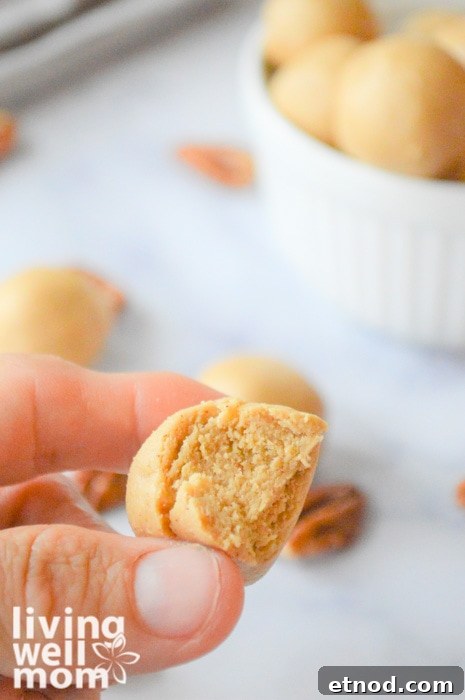Spiced Almond Butter Energy Bites for Quick Snacks 4 woman holding a energy ball with a bite taken out