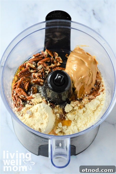 Spiced Almond Butter Energy Bites for Quick Snacks 6 Energy ball ingredients in a food processor