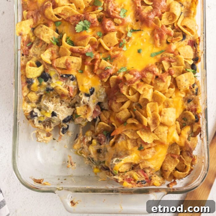 10 Simple Dishes You Can Make with a Can of Soup 3 Overhead view of the Frito casserole with a serving removed. Square image for featured image.