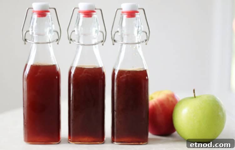 Boiled Apple Cider Syrup: Step-by-Step Recipe with Video 15 3 bottles of boiled apple cider with apples on a table