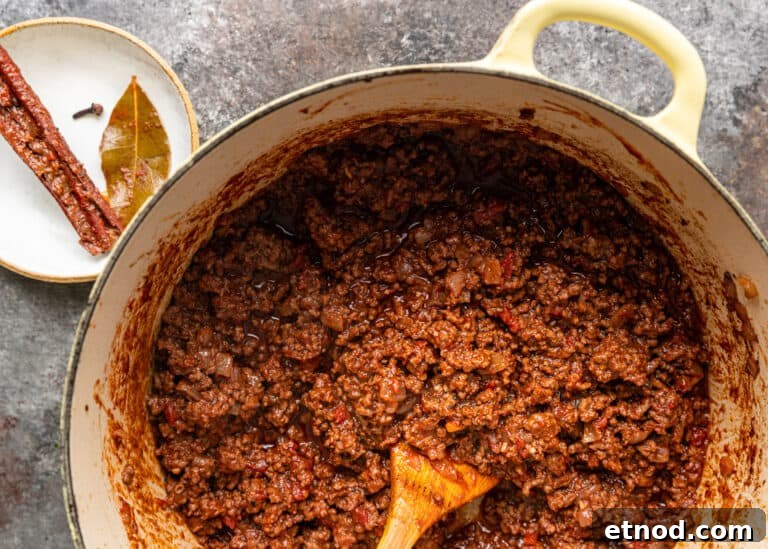 Authentic Greek Pastitsio Recipe: Classic Baked Pasta with Bechamel 6 overhead: large pot of meat sauce for Greek lasagna
