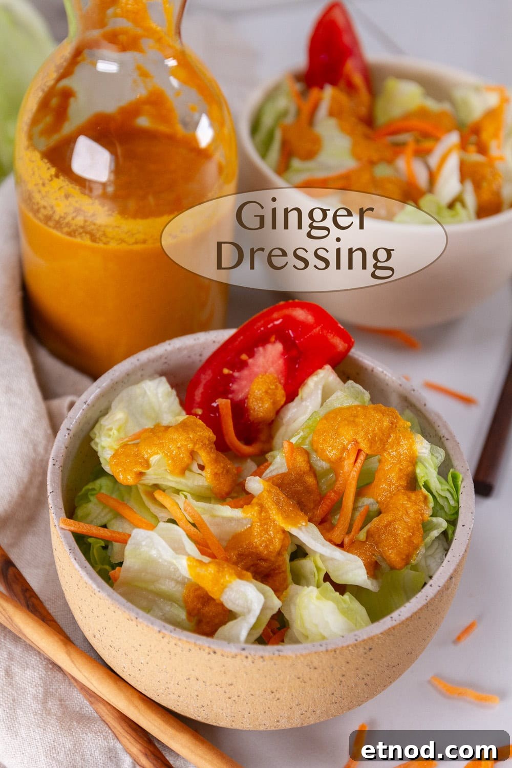 Ginger dressing in a bottle and poured out onto an iceberg salad.