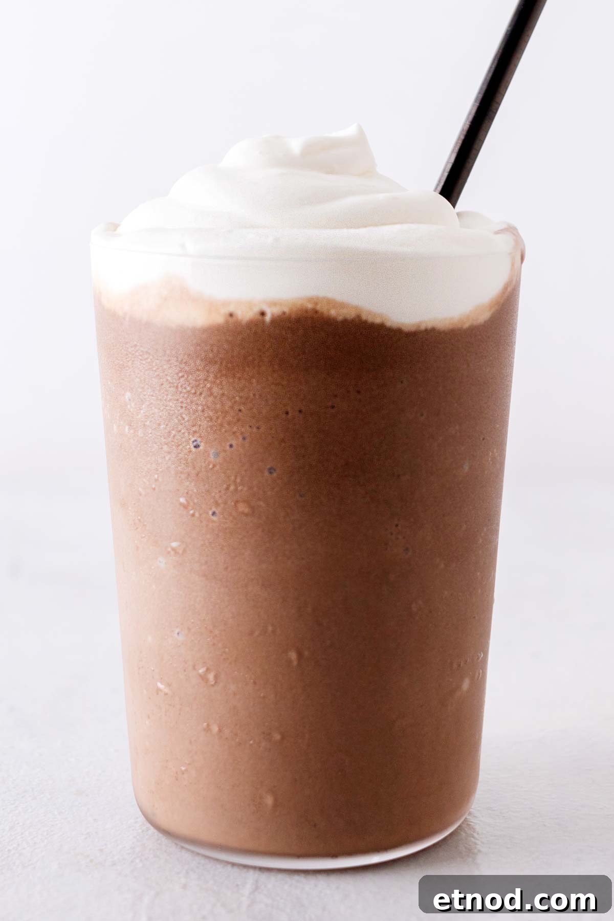 How to Make a Starbucks Mocha Frappuccino at Home 9 Homemade Mocha Frappuccino drink in a cup with whipped cream.