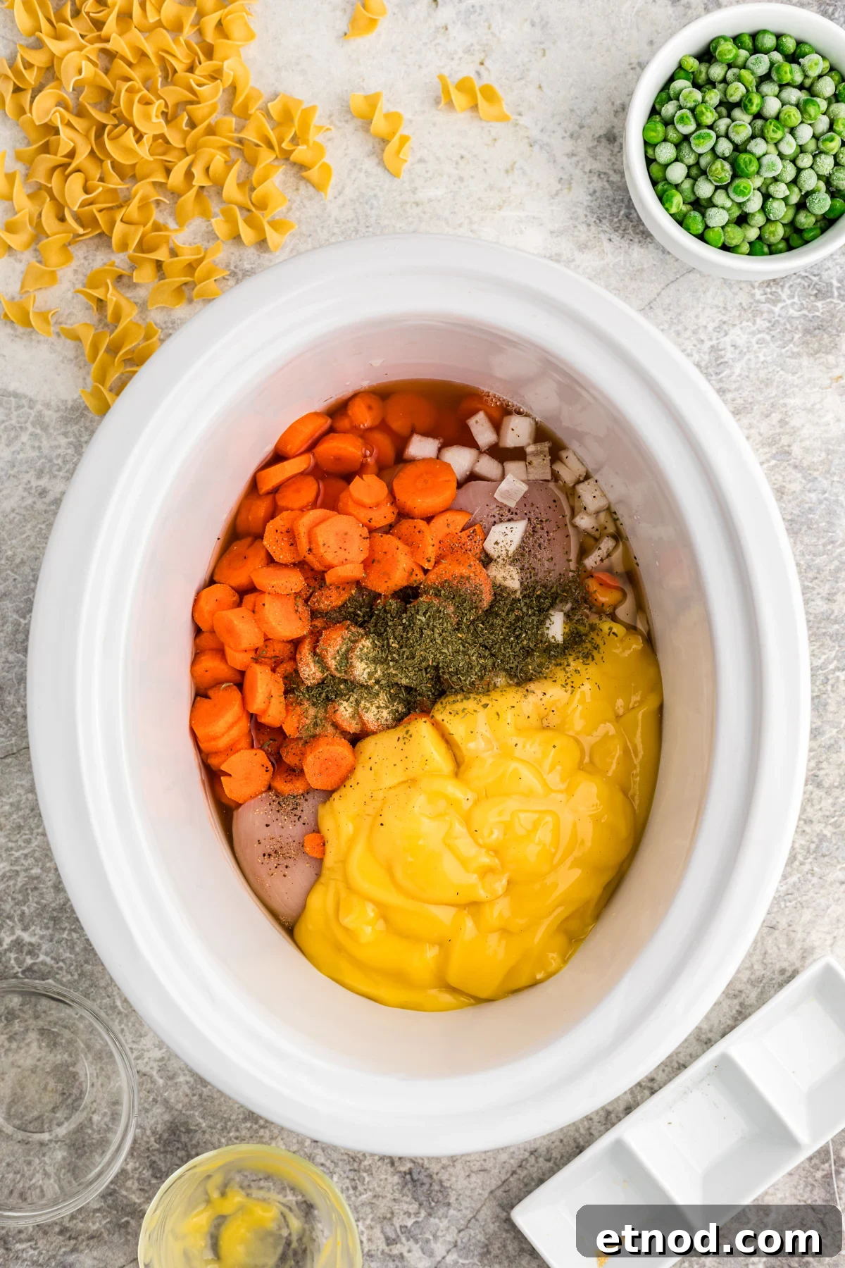 Creamy Slow Cooker Chicken and Noodles Recipe 4 Chicken, vegetables, seasonings and cream of chicken soup in a slow cooker.