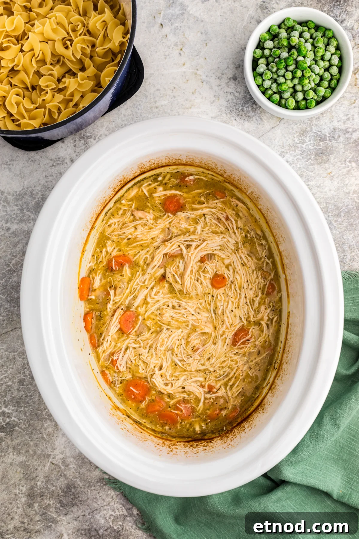 Creamy Slow Cooker Chicken and Noodles Recipe 5 shredded chicken in a slow cooker.