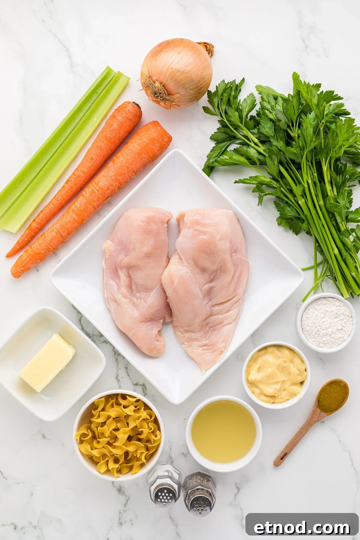 Creamy Homemade Chicken Noodle Soup Recipe for Comforting Dinner 3 chicken soup ingredients measured out and arranged on counter.