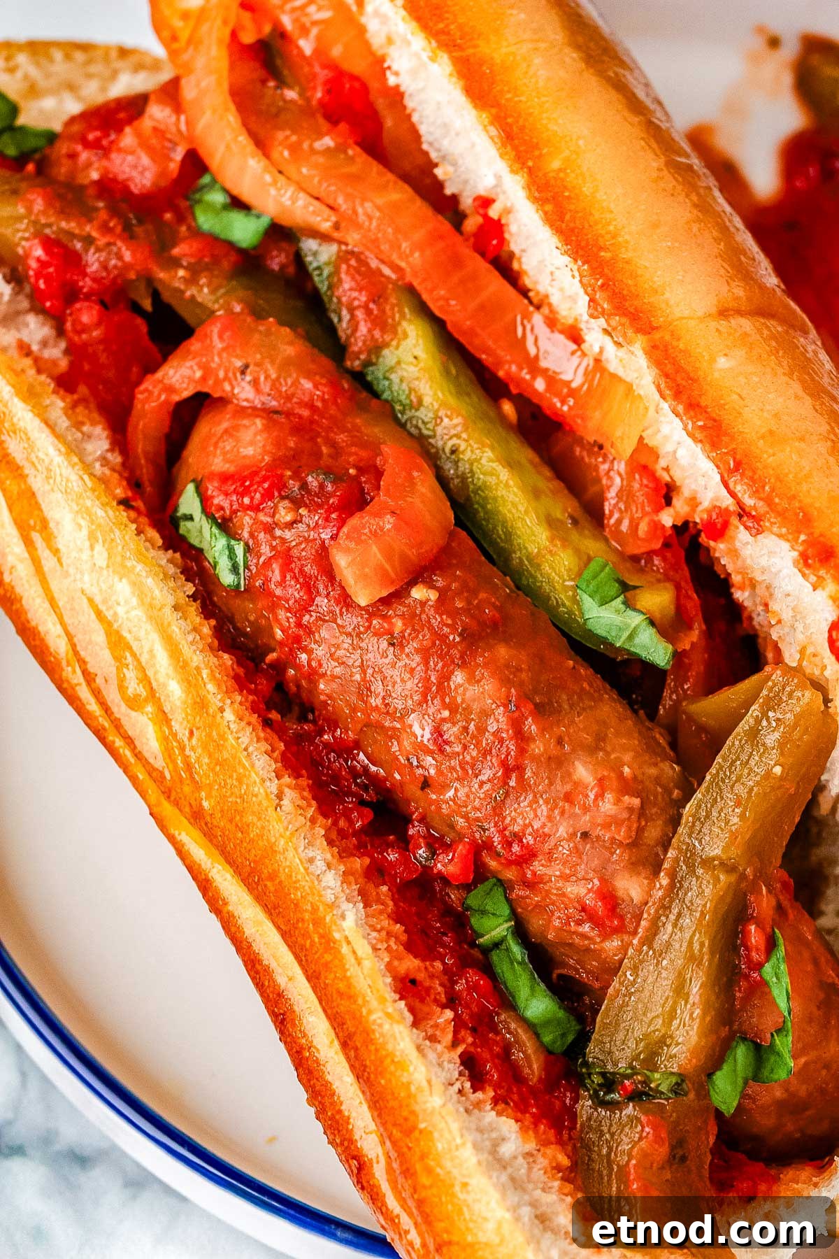 Slow Cooker Sausage and Peppers Recipe for Tender, Flavorful Meals 5 A close-up picture of Italian sausage and peppers in a toasted bun.