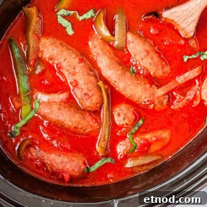 Slow Cooker Sausage and Peppers Recipe for Tender, Flavorful Meals 7 A close up picture of cooked sausage and peppers in a Crock Pot.