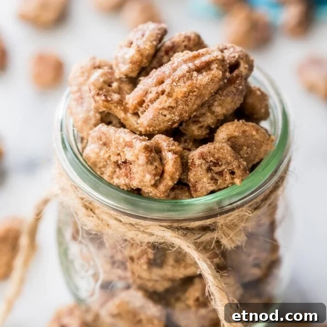 glass jar tied with twine filled with candied pecans