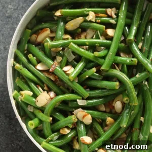 Green Bean Almondine Recipe: Sautéed Green Beans with Almonds 4 Green beans almondine cooked in a skillet.