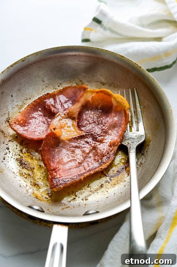 Southern-Style Deviled Eggs Recipe: Tangy Classic Appetizer 6 Fried country ham in a skillet.