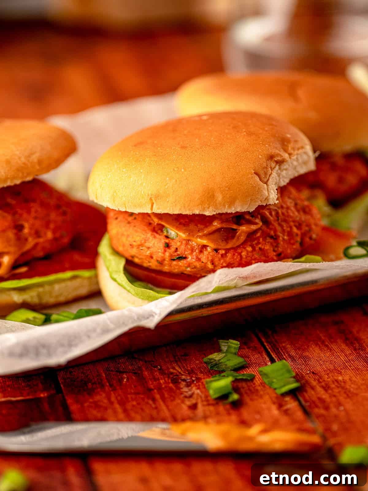 Crispy Baked Salmon Burgers with Lemon Dill Sauce 2 Salmon burgers on a tray.
