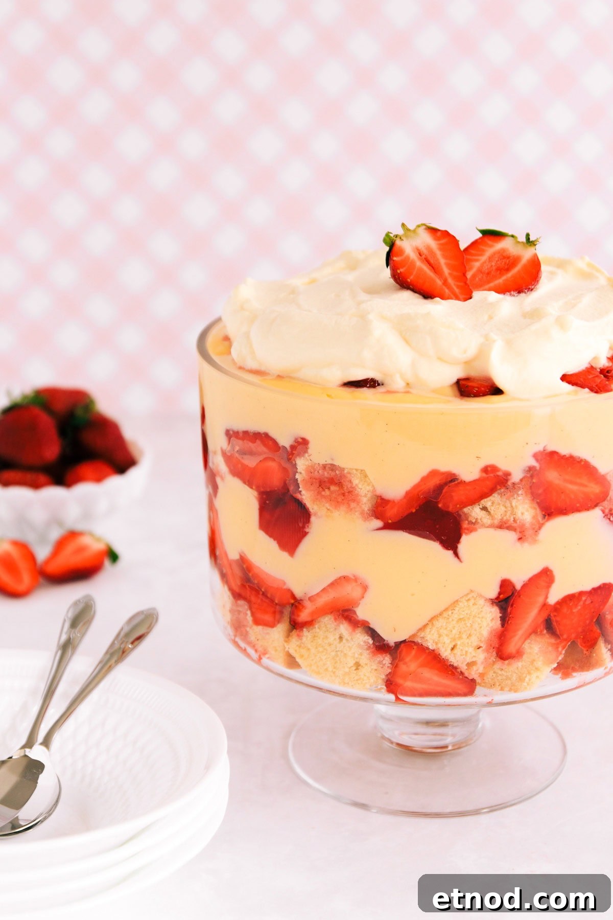 Gluten-Free Trifle Recipe: Light, Layered Dessert for Guests 2 Gluten free trifle in a footed glass bowl on a pink background.