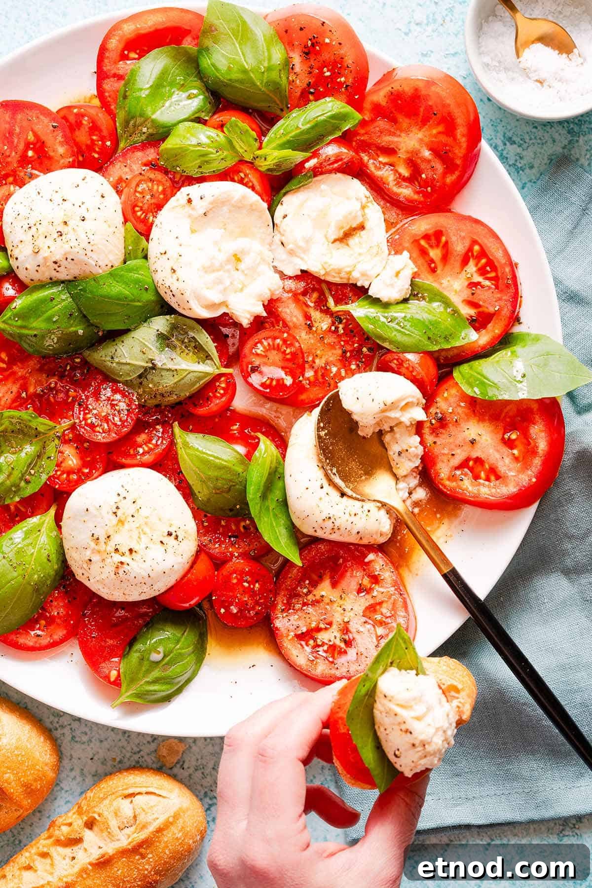 Creamy Burrata Caprese Salad with Heirloom Tomatoes 10 burrata caprese on platter with caprese on bread on the side.